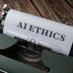 Retro typewriter with 'AI Ethics' on paper, conveying technology themes.