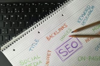 Close-up of notebook with SEO terms and keywords, highlighting digital marketing strategy.